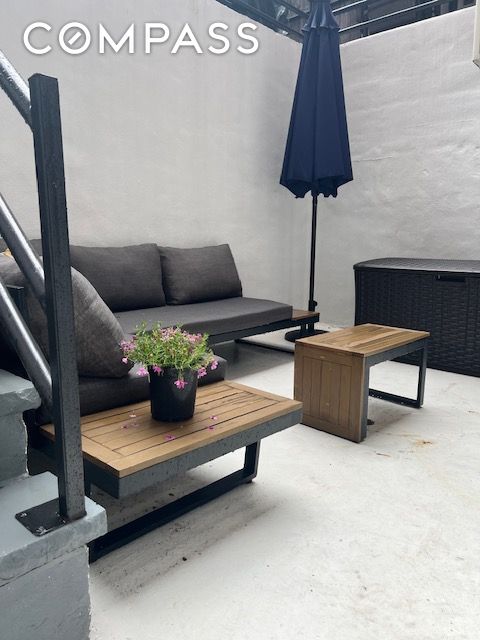 living area featuring unfinished concrete floors