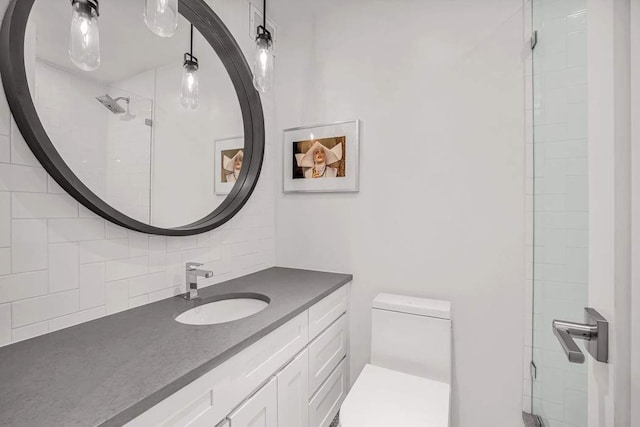 bathroom featuring decorative backsplash, toilet, and vanity