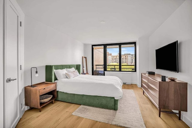 bedroom with light wood-style floors and baseboards