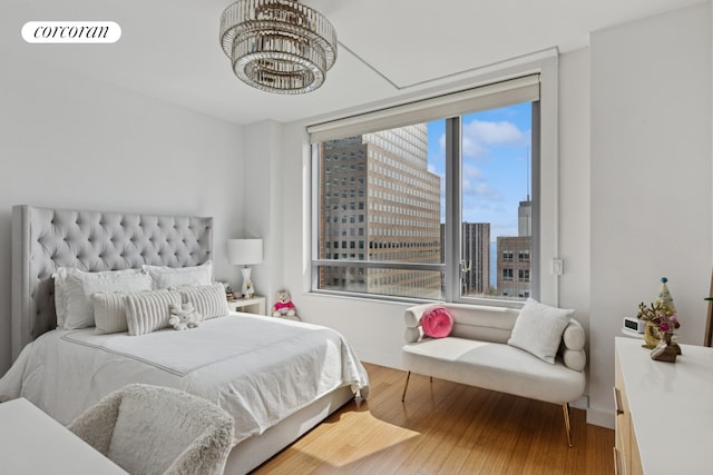 2 River Ter Unit 23C, New York City, NY 10282 - bedroom with a chandelier, wood finished floors, and a city view