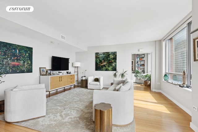 2 River Ter Unit 23C, New York City, NY 10282 - living room with light wood-style flooring and baseboards