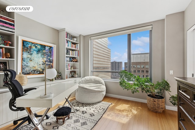 2 River Ter Unit 23C, New York City, NY 10282 - office area featuring wood finished floors, baseboards, and a city view