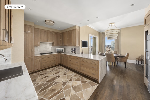30 Park Pl Unit 68A, New York City, NY 10007 - kitchen with a chandelier, a peninsula, a sink, backsplash, and crown molding