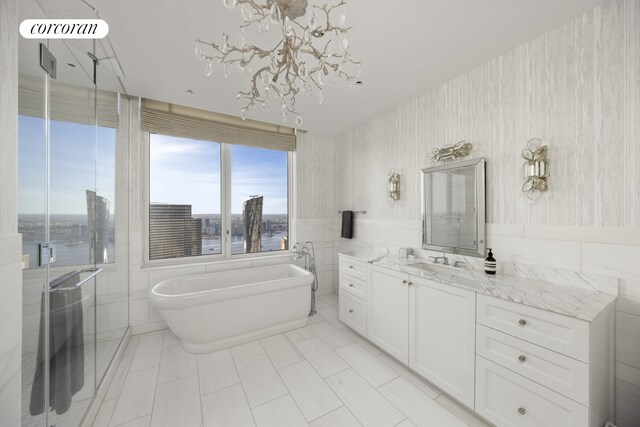 30 Park Pl Unit 68A, New York City, NY 10007 - bathroom featuring vanity, a freestanding bath, tile walls, a chandelier, and wallpapered walls