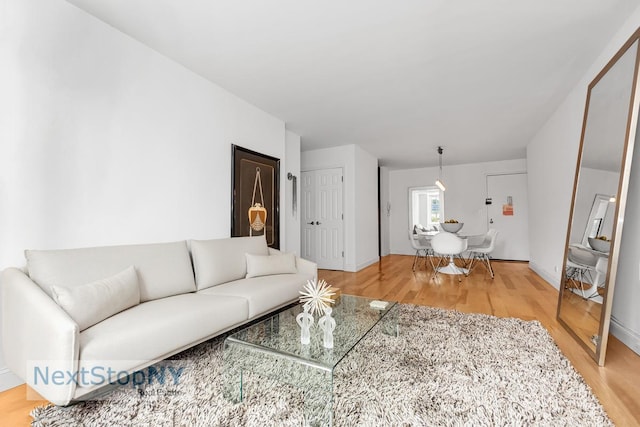 living room with light wood-style floors and baseboards