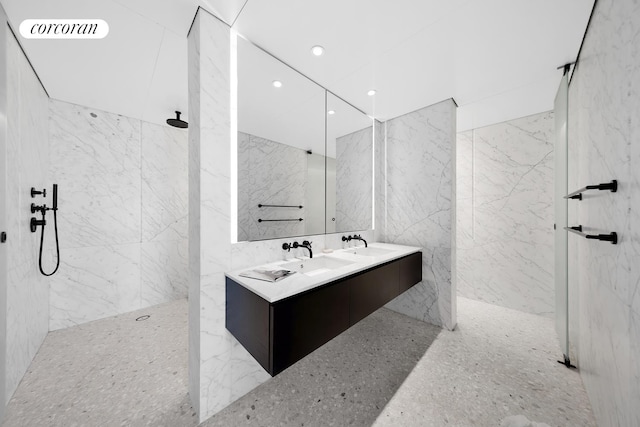 16 W 40th St Unit 29A, New York City, NY 10018 - bathroom featuring a marble finish shower, double vanity, tile walls, and recessed lighting
