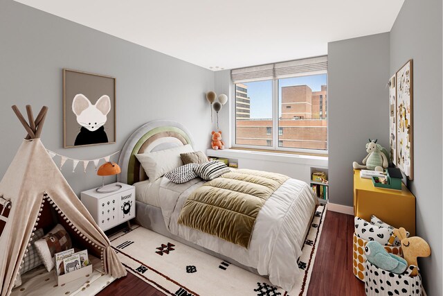 200 E 89th St Unit 27D, New York City, NY 10128 - bedroom with wood finished floors and baseboards