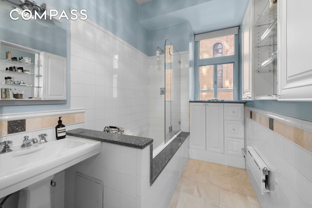 bathroom with a sink and tile walls