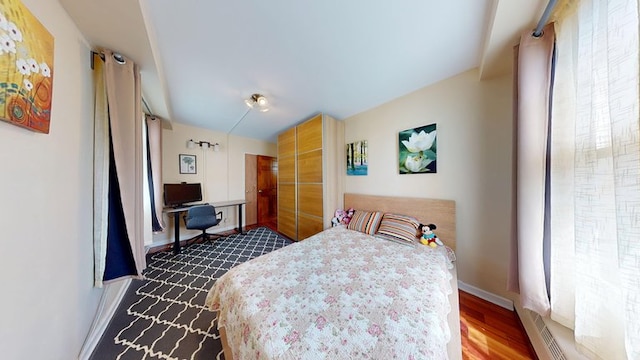 97-40 62nd Dr Unit 9K, New York City, NY 11374 - bedroom with dark wood-style floors and baseboards