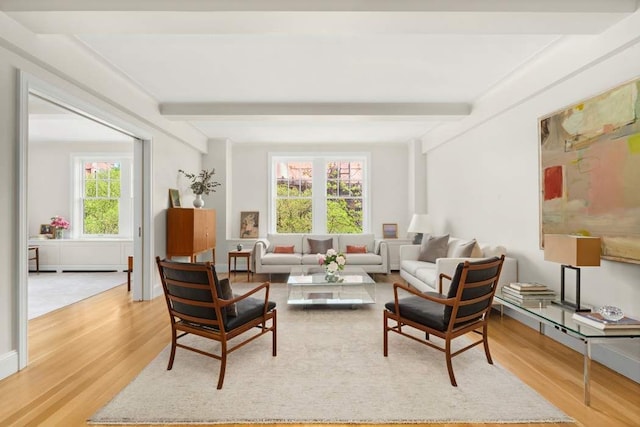living area with light wood-style floors and beam ceiling