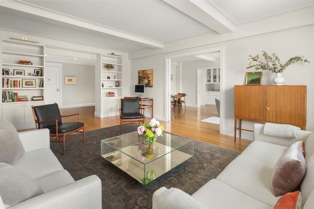 40 W 77th St Unit 7B, New York City, NY 10024 - living room featuring wood finished floors, beam ceiling, built in features, and baseboards