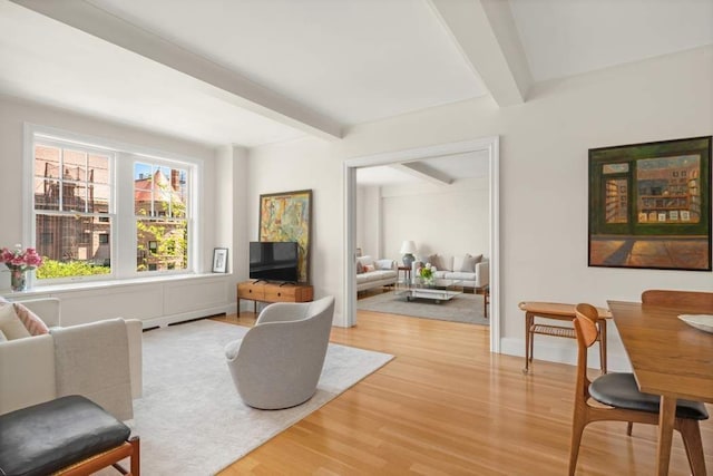 40 W 77th St Unit 7B, New York City, NY 10024 - living room featuring beamed ceiling, wood finished floors, and baseboards