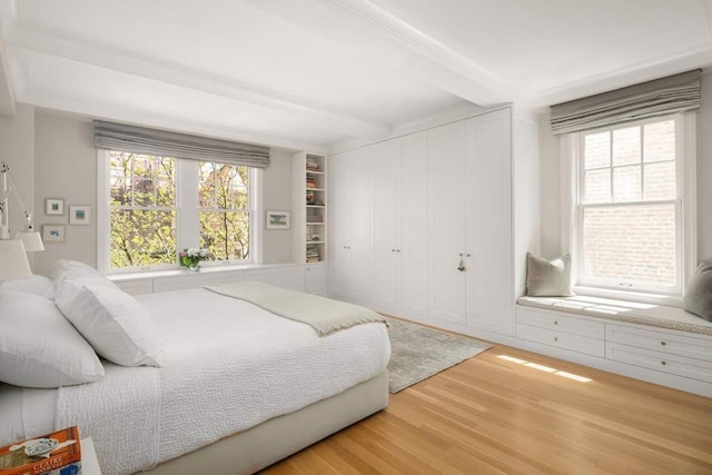 40 W 77th St Unit 7B, New York City, NY 10024 - bedroom with beamed ceiling, wood finished floors, multiple windows, and a closet