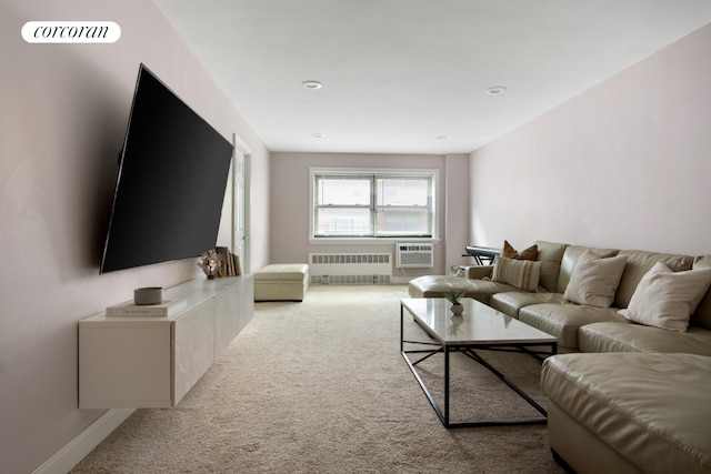 carpeted living area featuring radiator heating unit and an AC wall unit