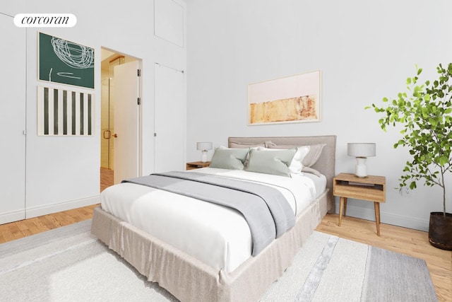 bedroom featuring wood finished floors and baseboards
