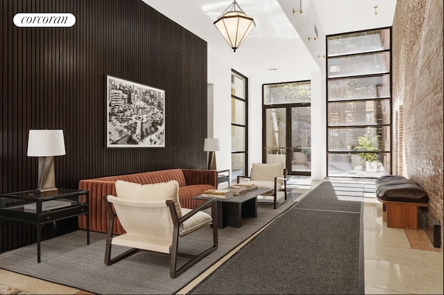 community lobby with a high ceiling and floor to ceiling windows