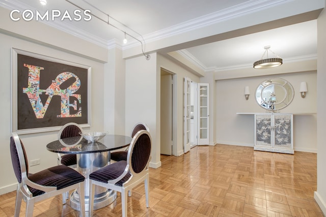 dining space featuring ornamental molding and baseboards