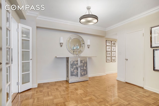 unfurnished room with ornamental molding and baseboards