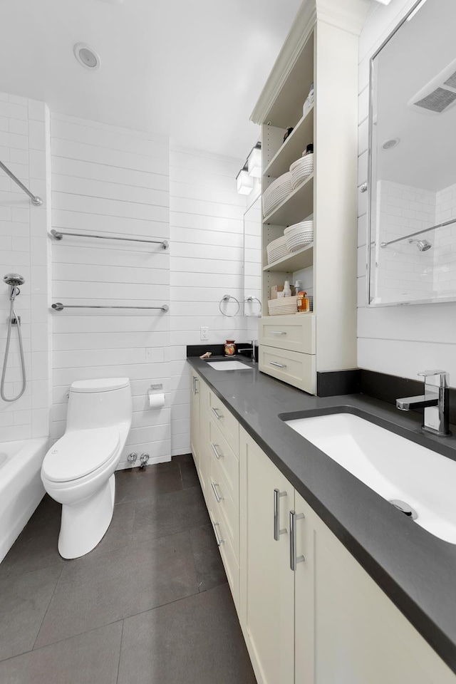 full bath featuring tile patterned flooring, toilet, and double vanity
