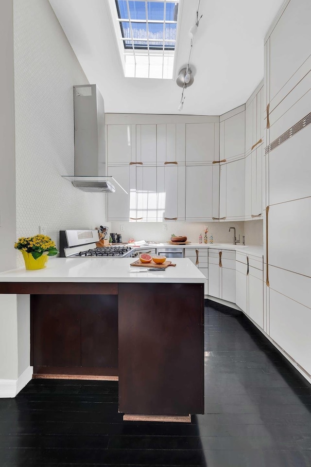 353 2nd St Unit 4L, New York City, NY 11215 - kitchen with wall chimney range hood, gas range oven, light countertops, white cabinets, and dark wood-style flooring