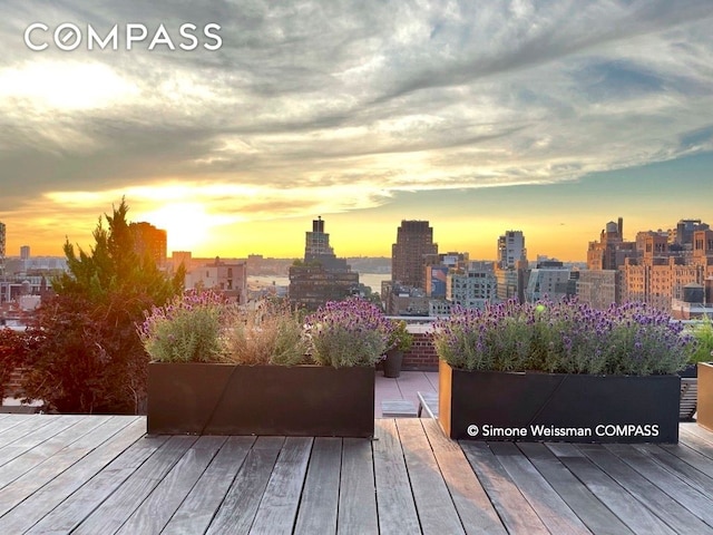 wooden terrace featuring a view of skyline