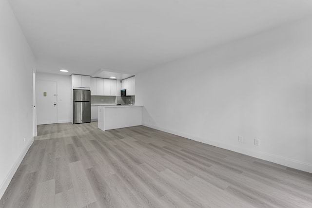 5700 Arlington Ave Unit 3P, New York City, NY 10471 - unfurnished living room with recessed lighting, light wood-type flooring, and baseboards