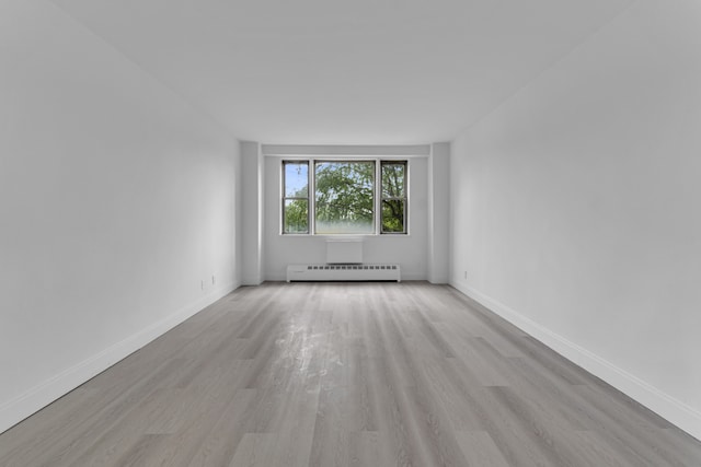 5700 Arlington Ave Unit 3P, New York City, NY 10471 - unfurnished room featuring a baseboard radiator, light wood-style flooring, and baseboards