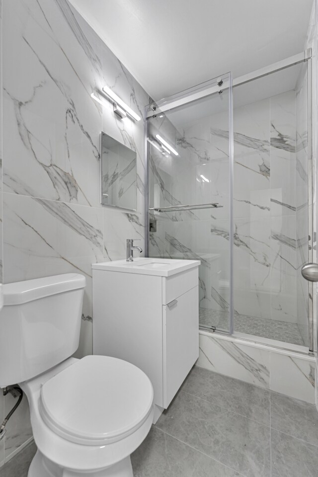 5700 Arlington Ave Unit 3P, New York City, NY 10471 - bathroom with a marble finish shower, marble finish floors, toilet, and vanity