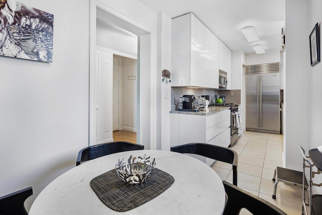 dining space with light tile patterned floors