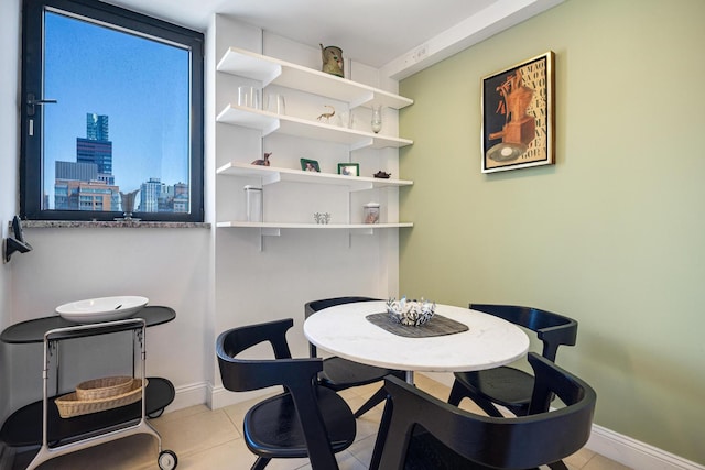 dining area with light tile patterned floors and baseboards