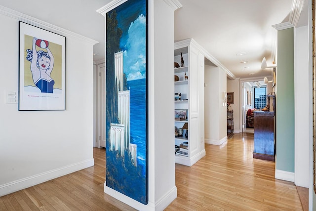 hall featuring light wood finished floors, baseboards, ornamental molding, and recessed lighting