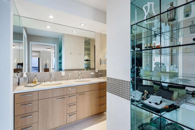 bathroom featuring tasteful backsplash, double vanity, and recessed lighting