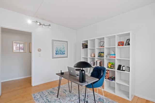 office featuring hardwood / wood-style floors and baseboards