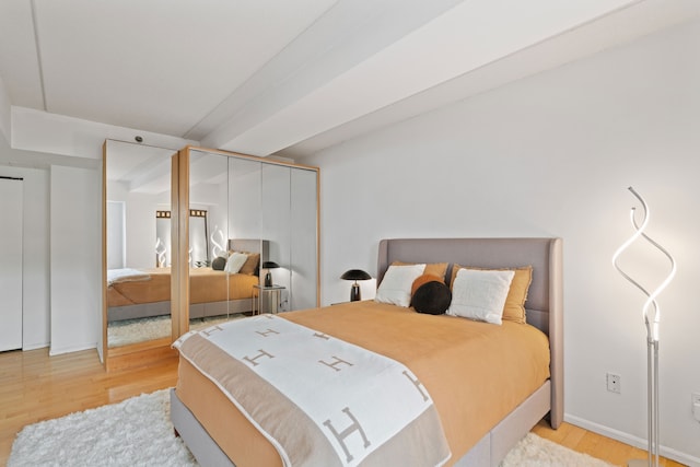 bedroom with wood finished floors and baseboards