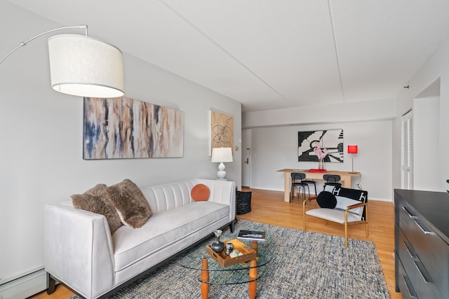 living room featuring a baseboard heating unit and light wood-style flooring