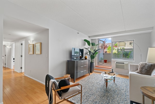 living area with light wood-type flooring and baseboards