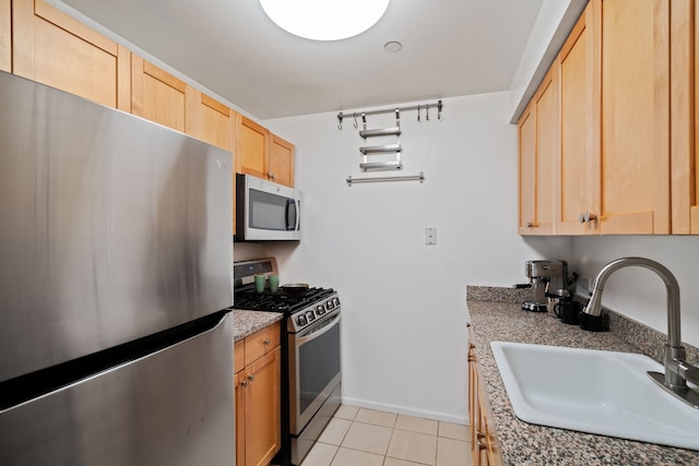 300 W 145th St Unit 1-N, New York City, NY 10039 - kitchen with appliances with stainless steel finishes, a sink, light brown cabinetry, light tile patterned floors, and baseboards