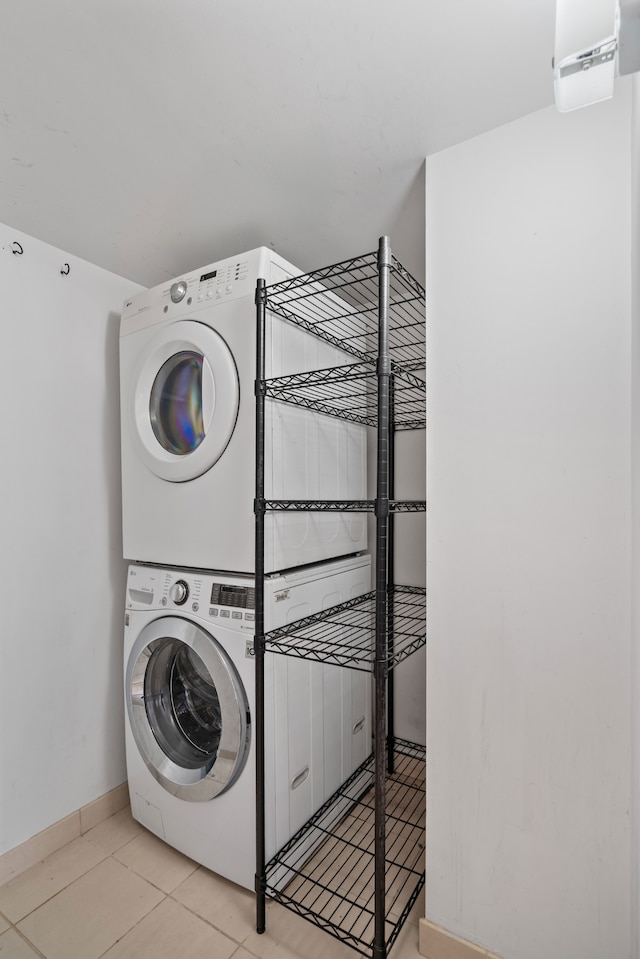 300 W 145th St Unit 1-N, New York City, NY 10039 - washroom with stacked washer and clothes dryer, baseboards, and tile patterned floors