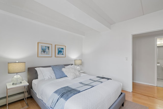 300 W 145th St Unit 1-N, New York City, NY 10039 - bedroom featuring a baseboard radiator, wood finished floors, and baseboards