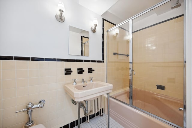full bathroom with tile walls, combined bath / shower with glass door, and tile patterned floors