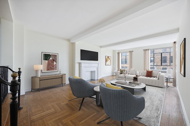 living area with baseboards, beamed ceiling, and a fireplace