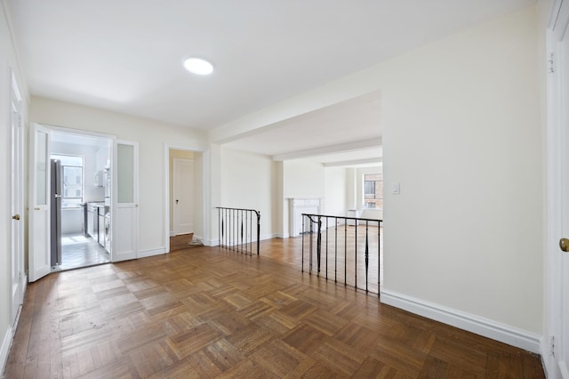 unfurnished room featuring baseboards