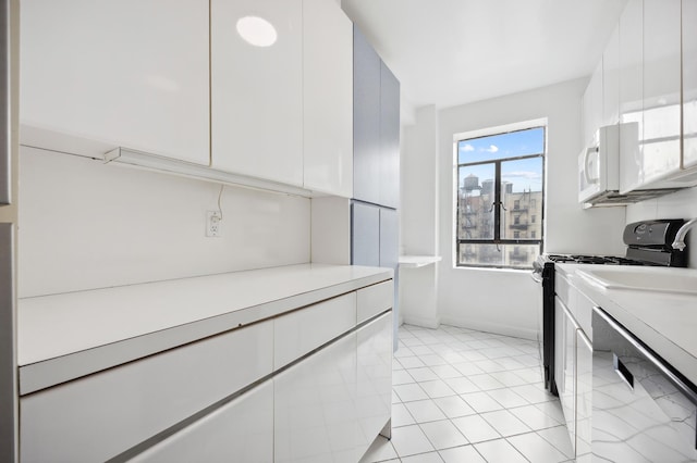 laundry room featuring light tile patterned floors