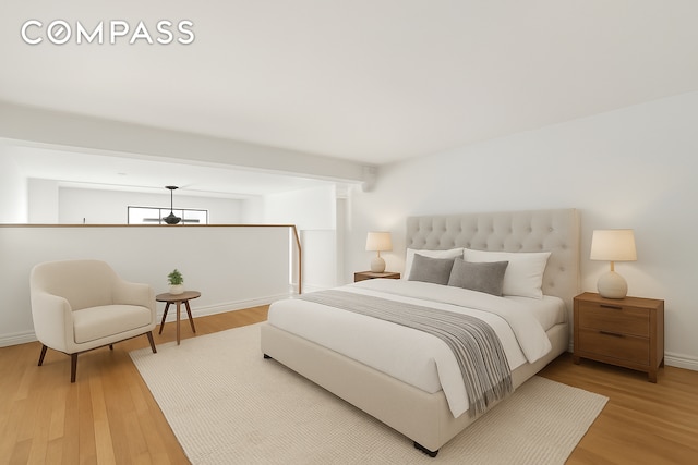 bedroom featuring light wood-type flooring and baseboards