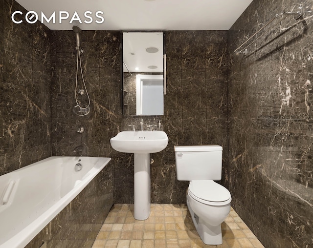 full bathroom featuring tile walls and toilet