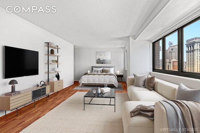 bedroom featuring wood finished floors and a textured ceiling