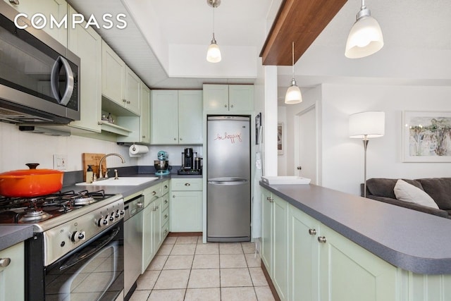 kitchen featuring stainless steel appliances, a sink, dark countertops, and light tile patterned floors