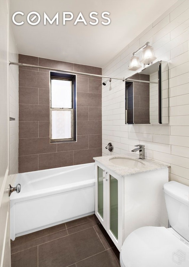 156-08 Riverside Dr W Unit 1K, New York City, NY 10032 - bathroom with tile patterned flooring, vanity, shower / washtub combination, and tile walls