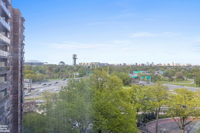 water view with nearby urban area and a tree filled landscape