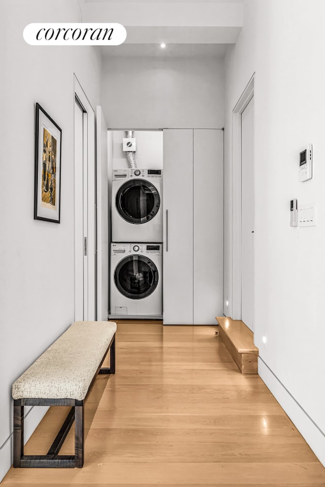 50 W 29th St Unit 2E, New York City, NY 10001 - laundry area featuring stacked washer / drying machine and light wood finished floors